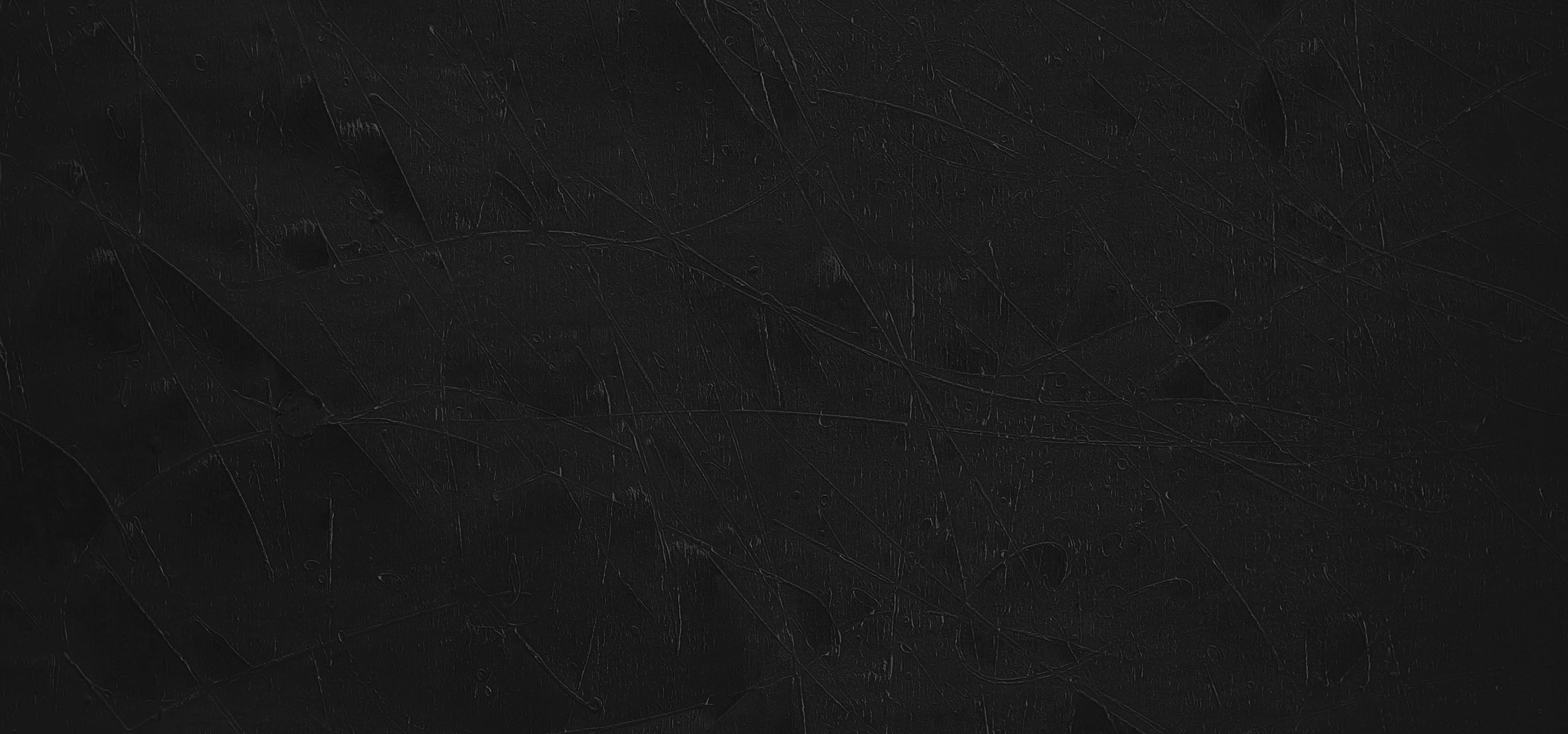 Black textured background with subtle scratches.