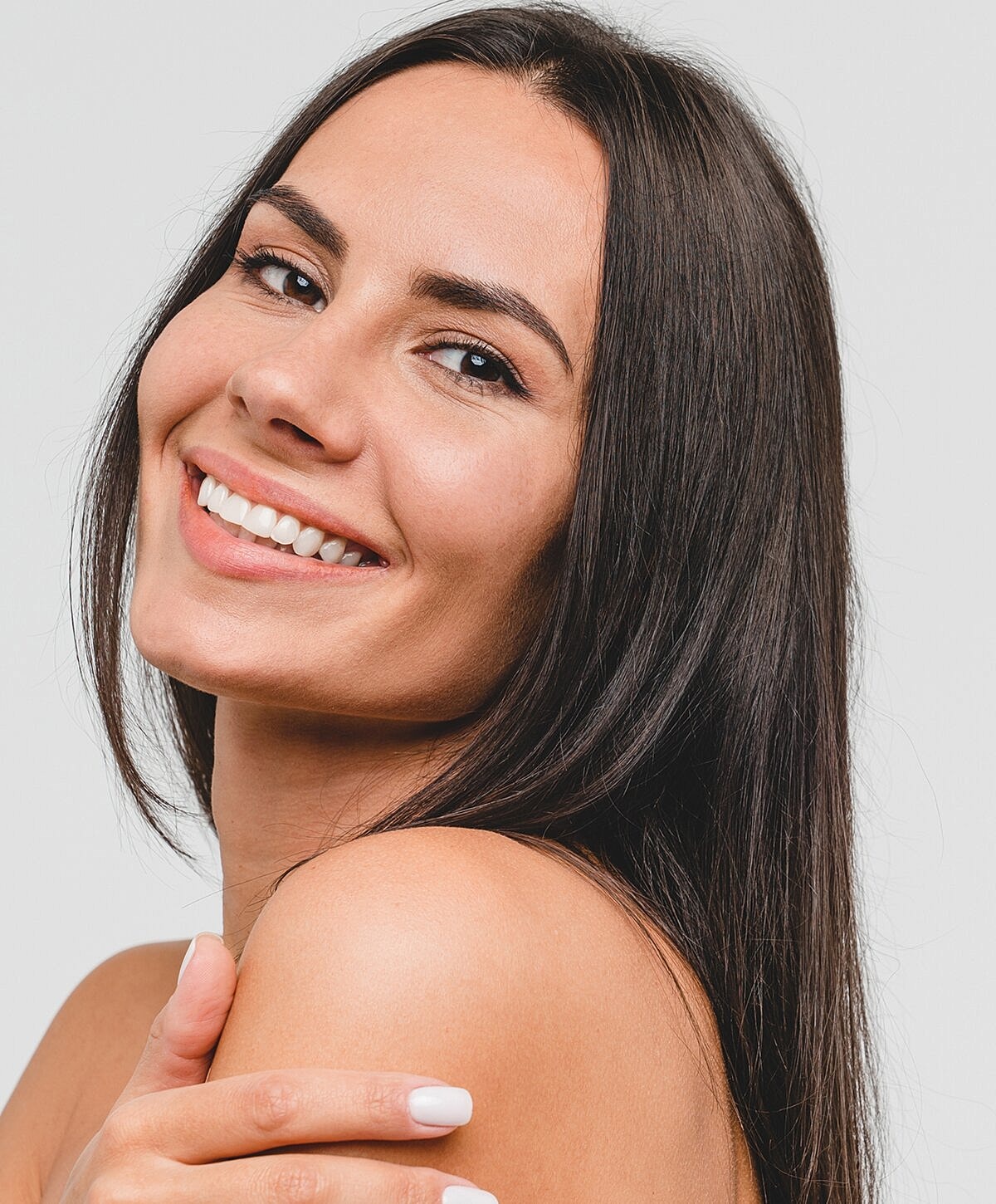 Smiling woman with long, dark hair.