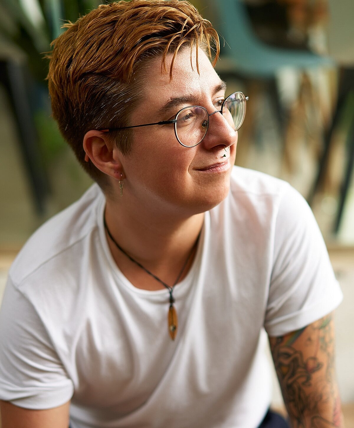 Person with short hair smiling indoors.