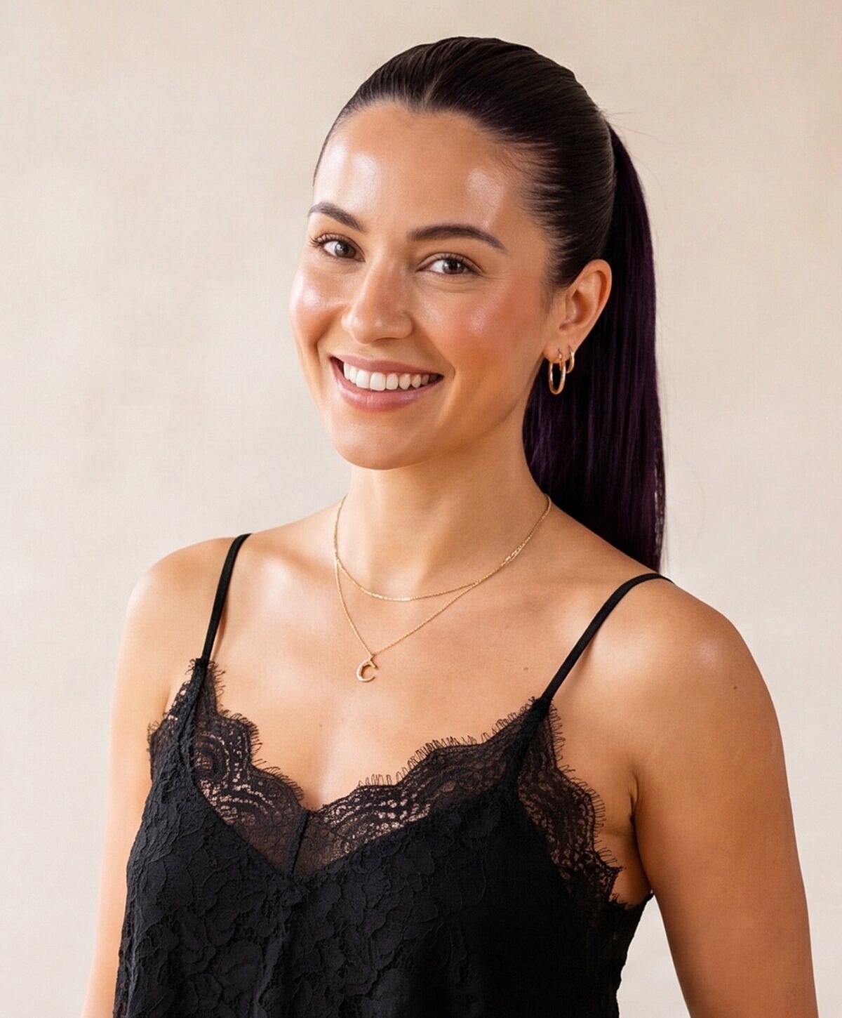 Woman smiling in black lace outfit.