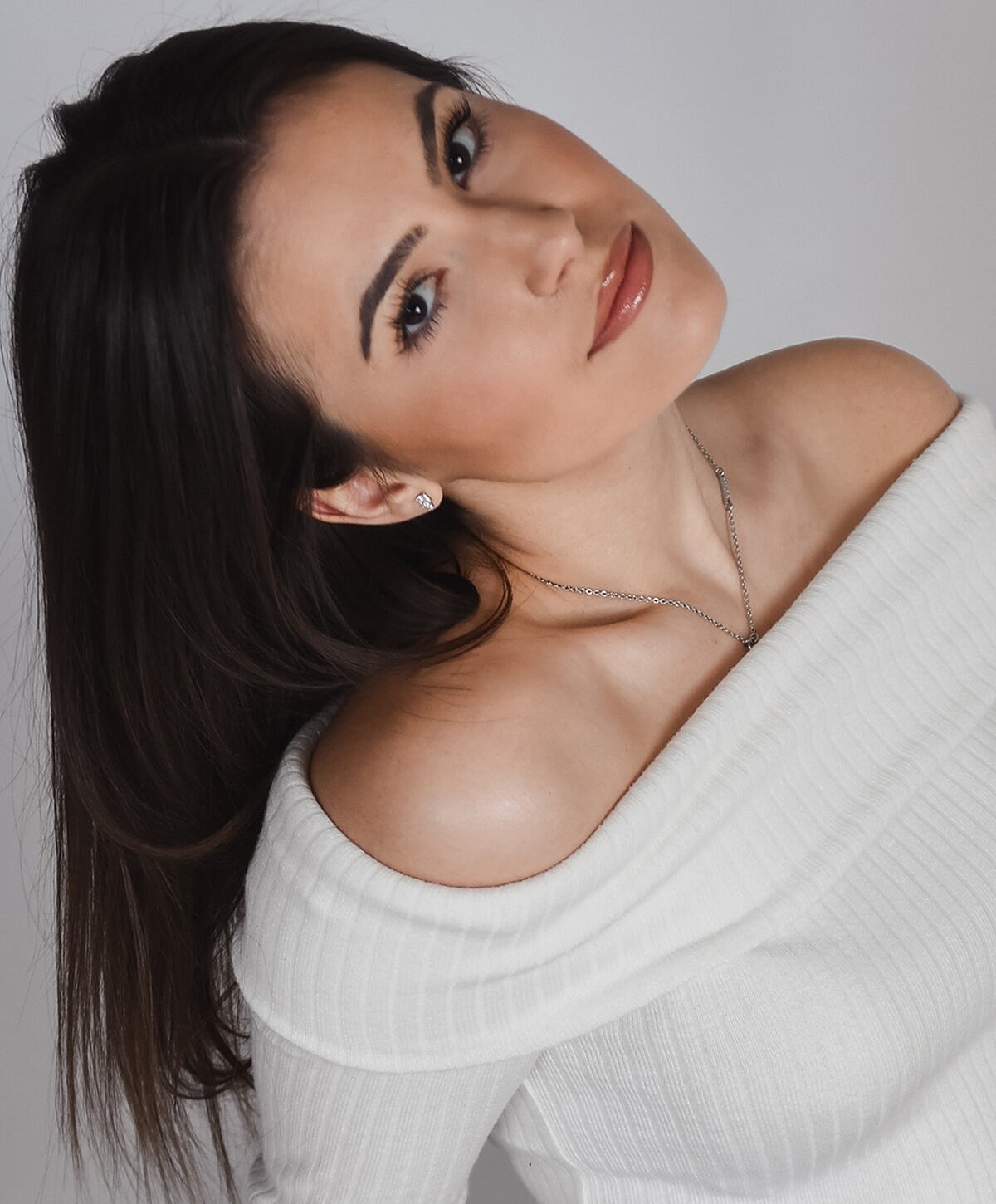Portrait of a woman in off-shoulder top.