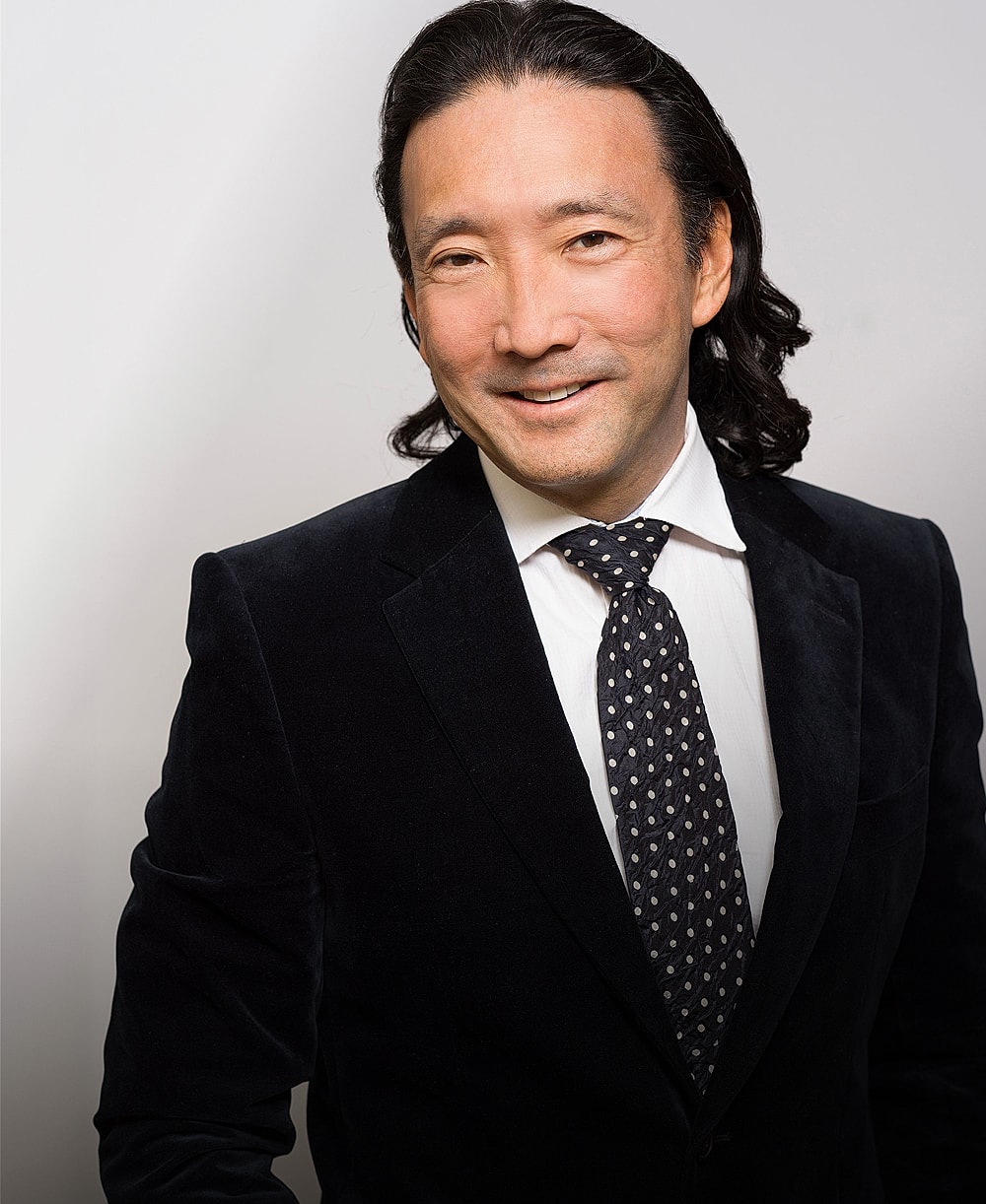 Man in suit with polka dot tie.