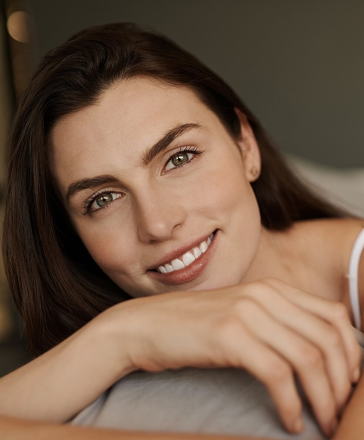 Smiling woman with long hair close-up portrait.
