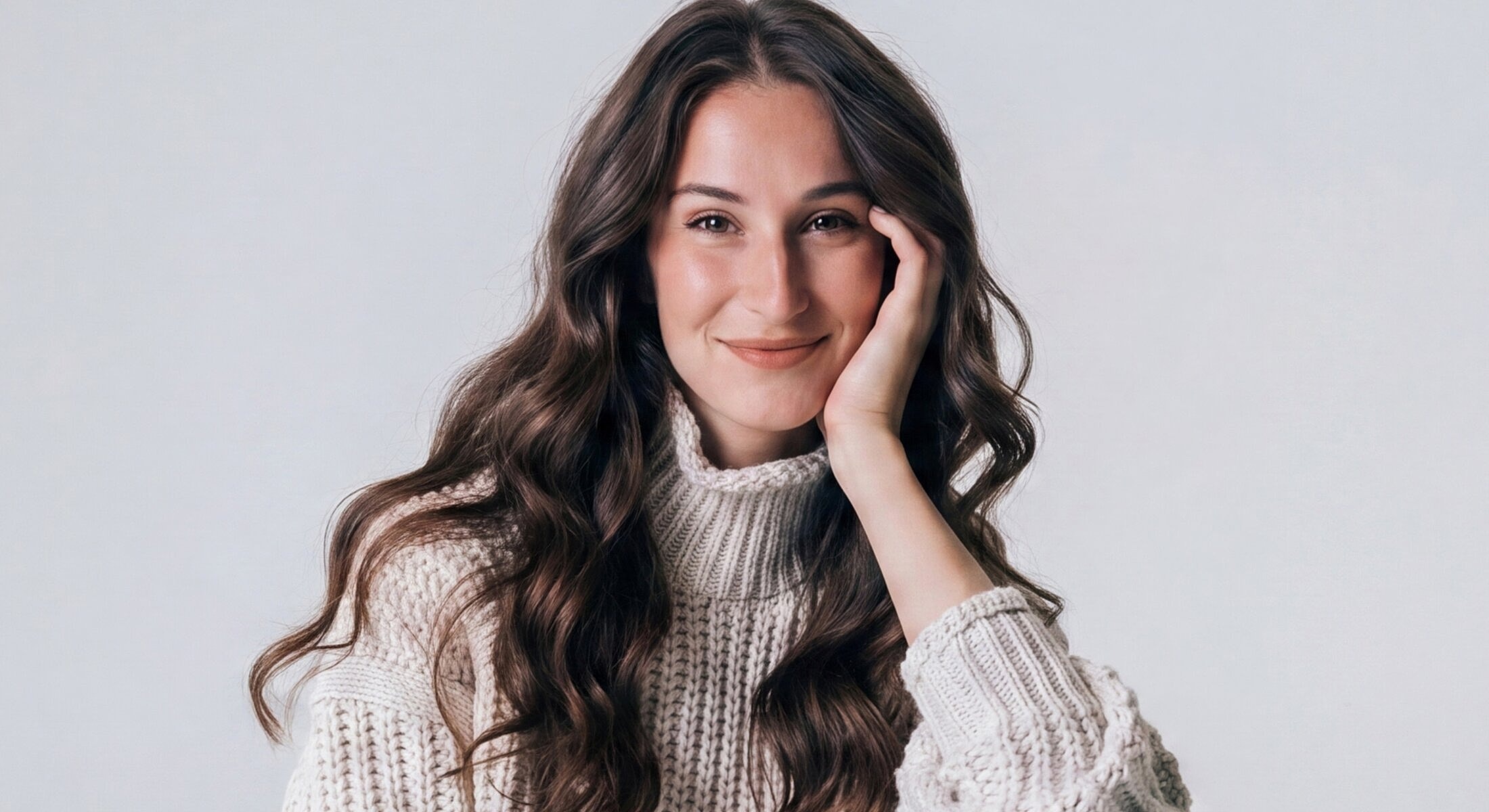 Smiling woman in cozy knit sweater.
