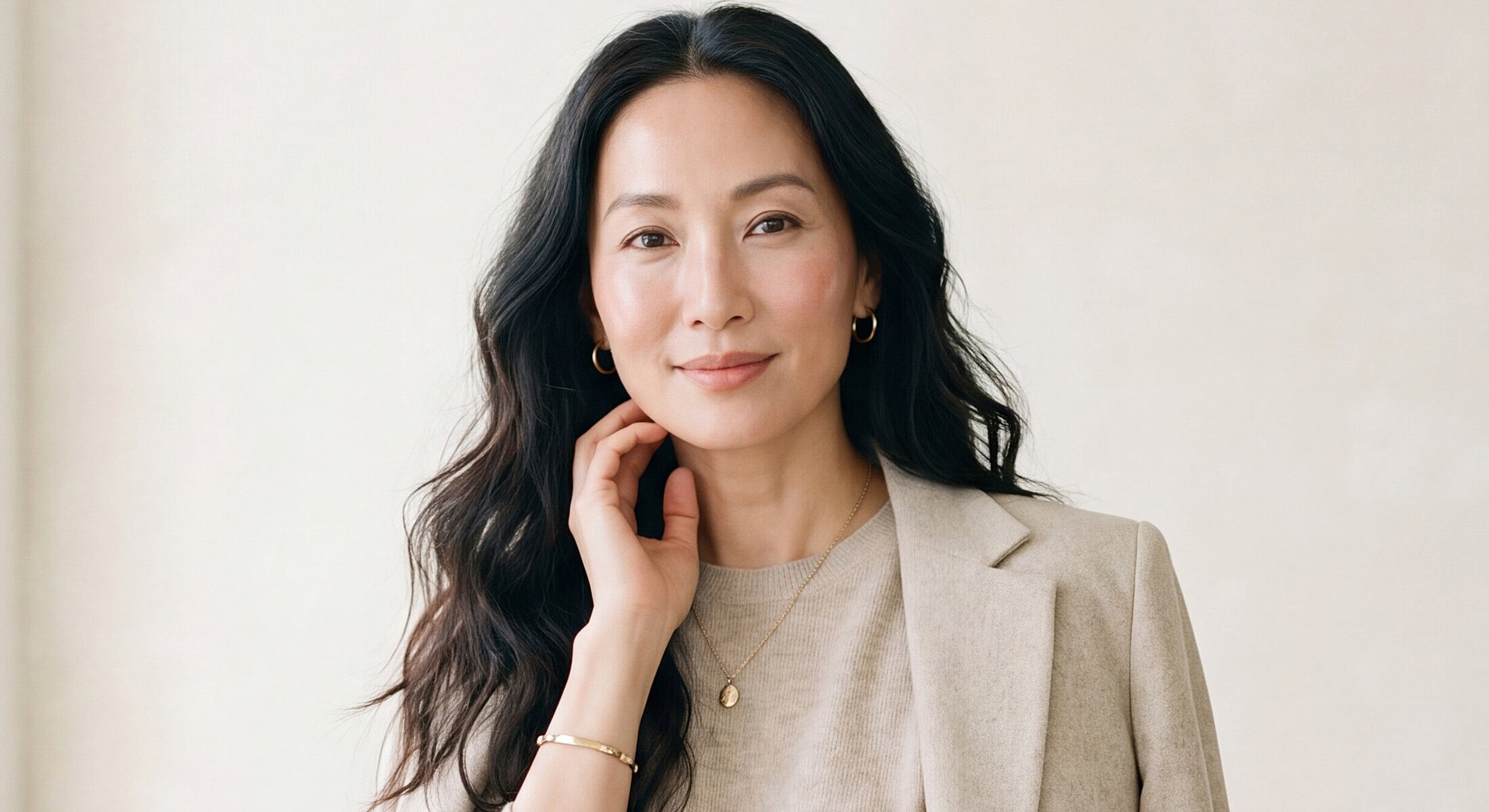 Woman with long hair in professional attire.