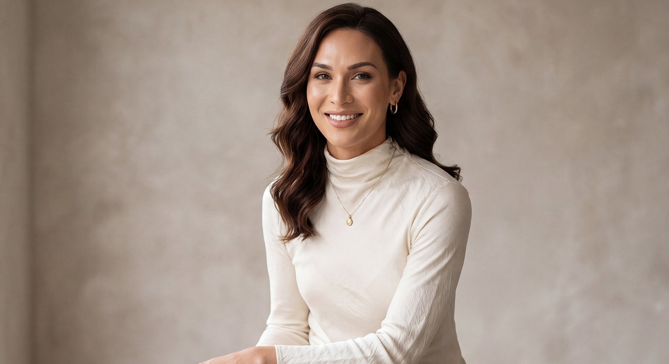 Smiling woman in a light turtleneck sweater.