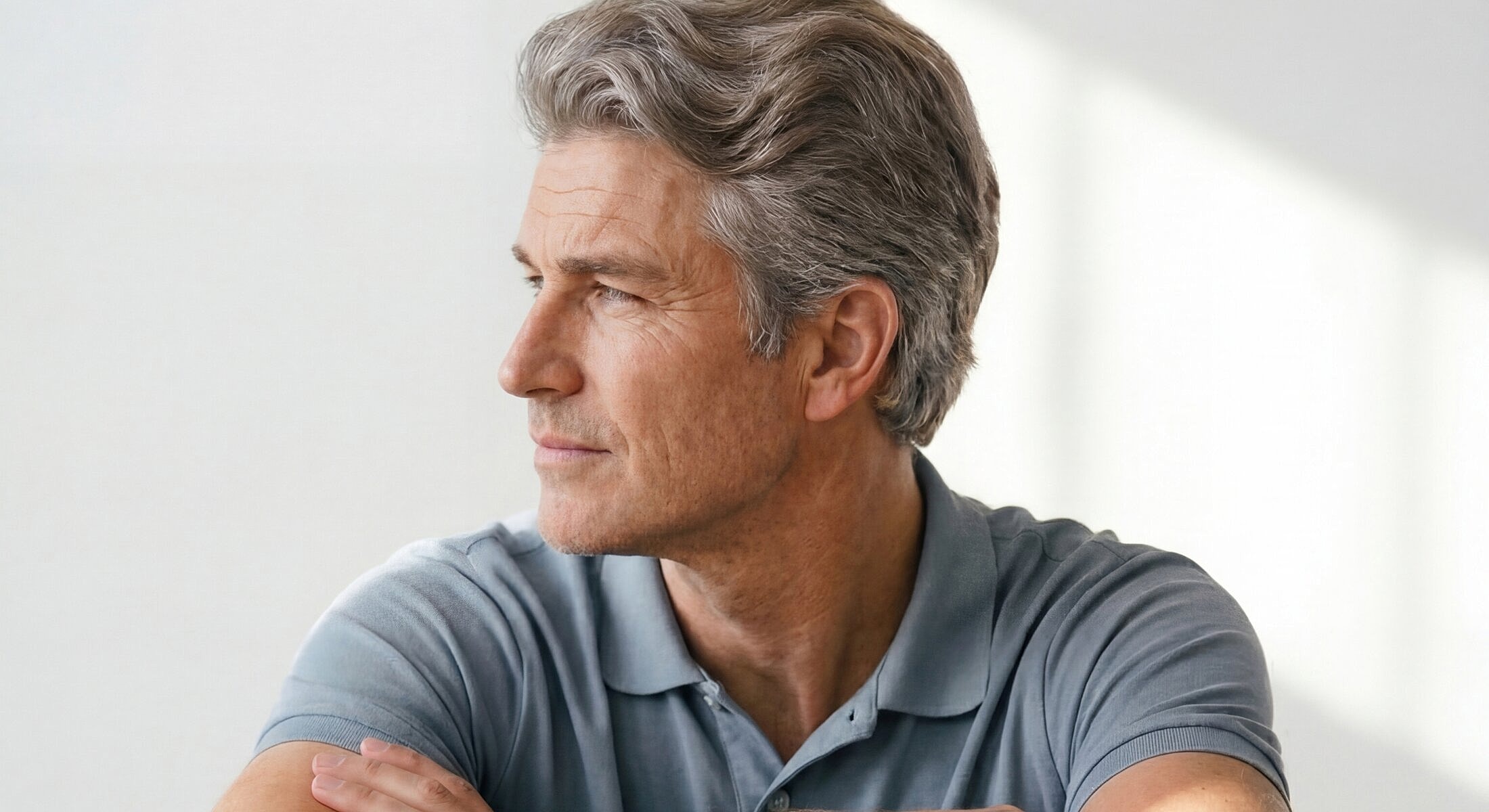 Thoughtful man with gray hair, portrait style.